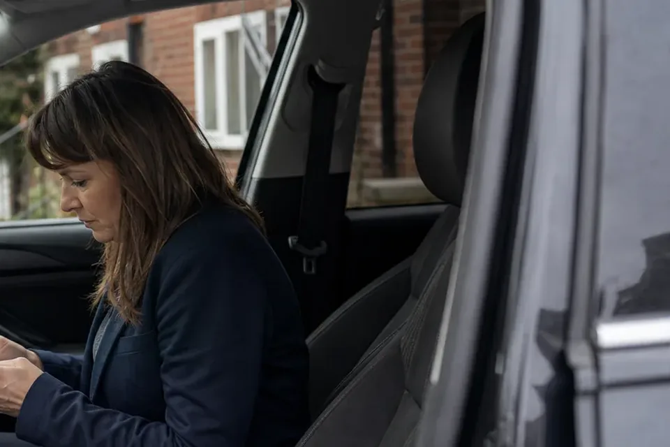Estate agent checking the next booked viewing on her phone